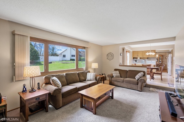 living area with an inviting chandelier, a wealth of natural light, and light carpet