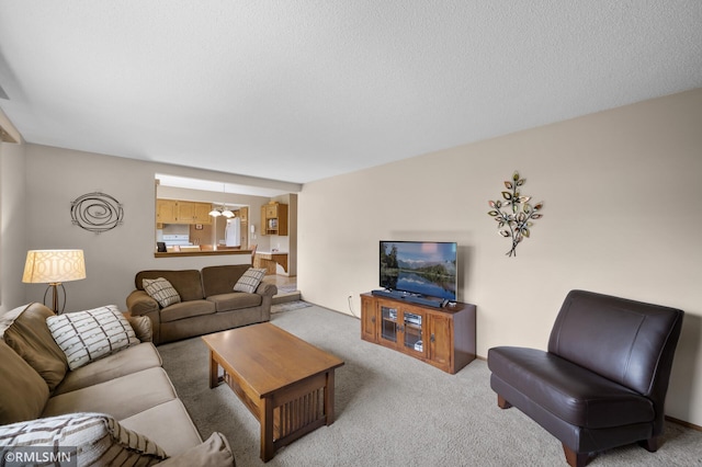 living room featuring carpet and a notable chandelier