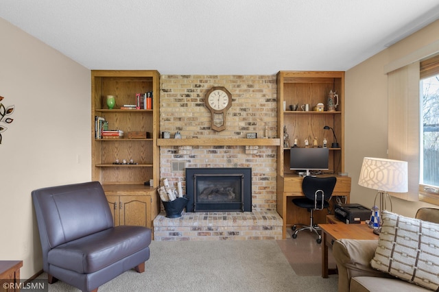 carpeted living room with a brick fireplace