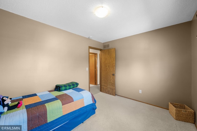bedroom with visible vents, carpet floors, and baseboards