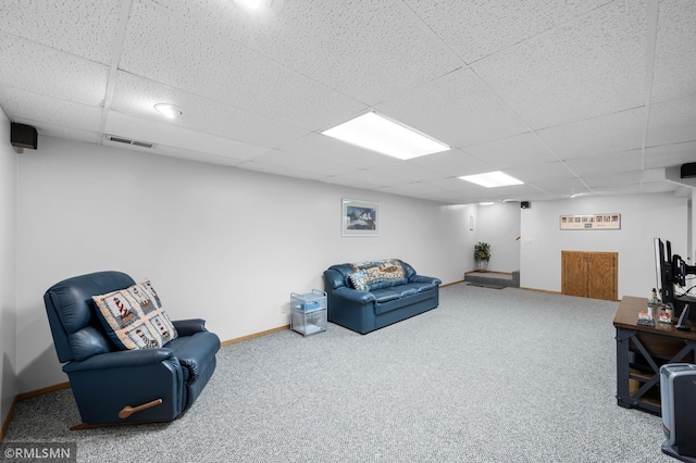 living area with baseboards, visible vents, carpet flooring, and a drop ceiling