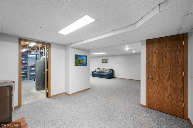finished below grade area featuring carpet, a drop ceiling, and baseboards
