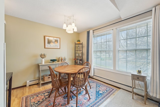 4654 Cedar Lake Rd S Unit 6, Saint Louis Park, MN 55416 - dining room with baseboards, light wood finished floors, a chandelier, and baseboard heating