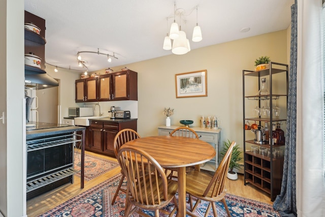 4654 Cedar Lake Rd S Unit 6, Saint Louis Park, MN 55416 - dining area with an inviting chandelier and light wood-style flooring