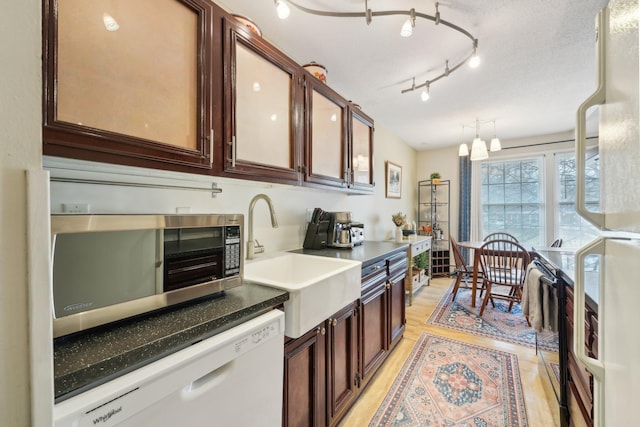 4654 Cedar Lake Rd S Unit 6, Saint Louis Park, MN 55416 - kitchen featuring dark brown cabinetry, white dishwasher, light wood-type flooring, stainless steel microwave, and a sink
