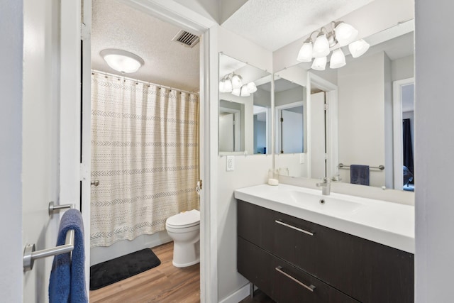 4654 Cedar Lake Rd S Unit 6, Saint Louis Park, MN 55416 - full bathroom with visible vents, wood finished floors, vanity, toilet, and shower / bathtub combination with curtain
