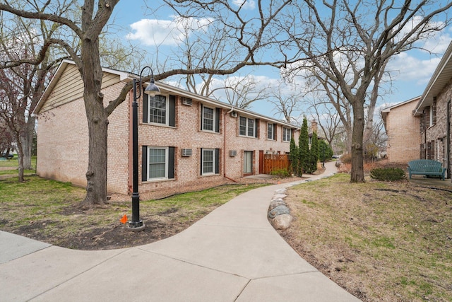4654 Cedar Lake Rd S Unit 6, Saint Louis Park, MN 55416 - exterior space featuring brick siding and a front lawn