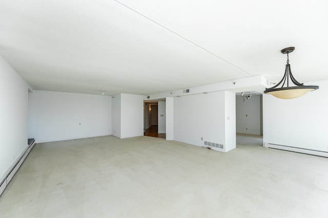 unfurnished living room featuring a baseboard heating unit, baseboard heating, and light colored carpet