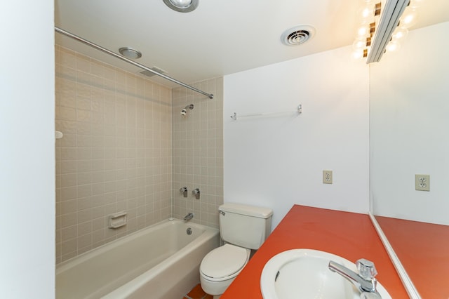 full bathroom featuring a sink, shower / washtub combination, and toilet