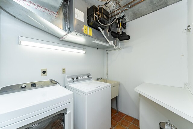 washroom with washing machine and clothes dryer and tile patterned flooring