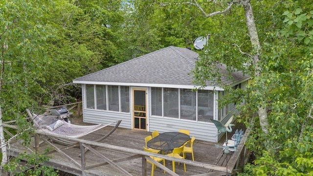 95536 Pine Is, Greenwood Twp, MN 55790 - back of property with roof with shingles, a sunroom, and a deck