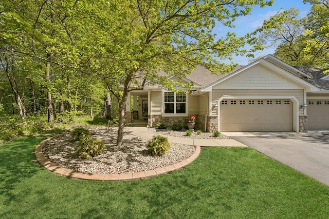 17300 Tilia Rdg, Eden Prairie, MN 55347 - view of front of house featuring asphalt driveway, a garage, stone siding, a front yard, and roof with shingles