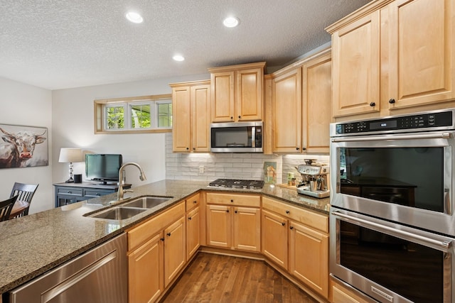 17300 Tilia Rdg, Eden Prairie, MN 55347 - kitchen with stainless steel appliances, a sink, dark wood-style floors, light brown cabinetry, and dark stone counters