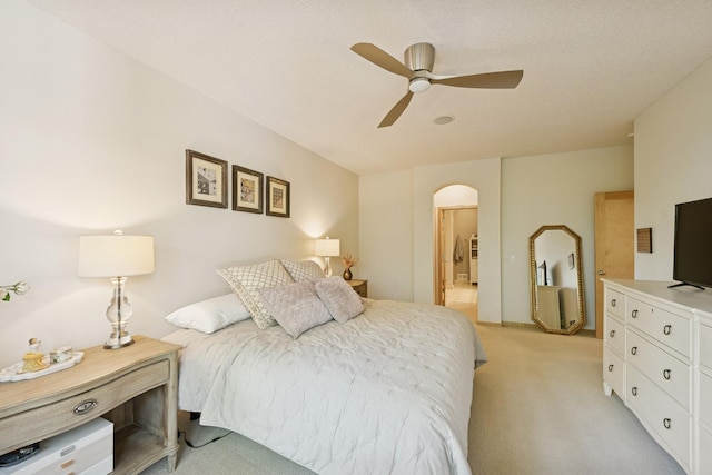 17300 Tilia Rdg, Eden Prairie, MN 55347 - bedroom with light carpet, arched walkways, ceiling fan, and connected bathroom