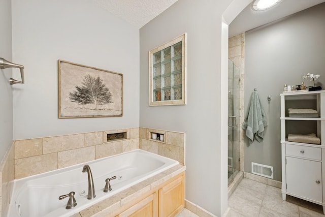 17300 Tilia Rdg, Eden Prairie, MN 55347 - bathroom with a stall shower, a tub with jets, tile patterned flooring, baseboards, and a textured ceiling