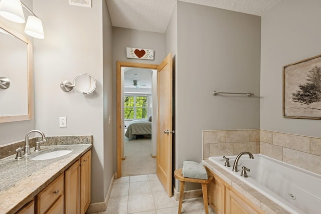 17300 Tilia Rdg, Eden Prairie, MN 55347 - ensuite bathroom with vanity, a textured ceiling, a jetted tub, tile patterned flooring, and baseboards