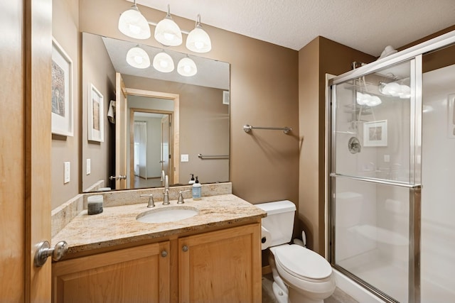 17300 Tilia Rdg, Eden Prairie, MN 55347 - bathroom with toilet, vanity, a shower stall, and a textured ceiling