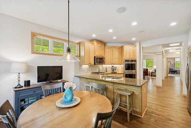 17300 Tilia Rdg, Eden Prairie, MN 55347 - dining area featuring light wood-type flooring, recessed lighting, and ornate columns