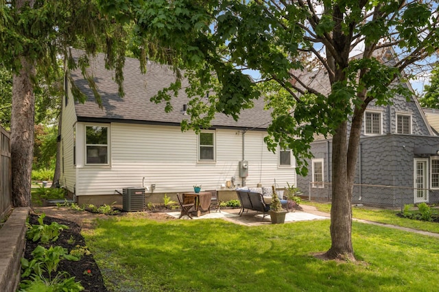 4836 Bloomington Ave, Minneapolis, MN 55417 - back of property with a patio area, central air condition unit, a shingled roof, and a lawn