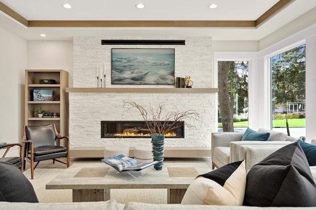 living room with recessed lighting, wood finished floors, and a fireplace