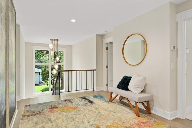 interior space with baseboards, recessed lighting, and wood finished floors