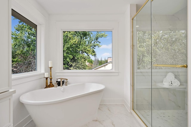 full bath featuring a marble finish shower, marble finish floor, a soaking tub, and baseboards