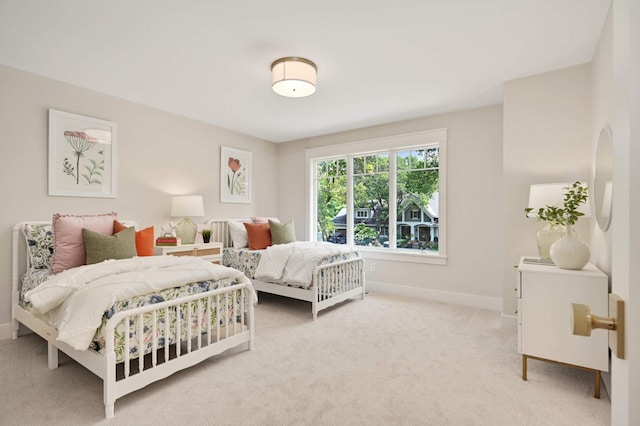 carpeted bedroom featuring baseboards