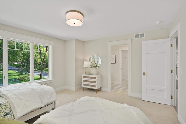 bedroom featuring visible vents, carpet flooring, and baseboards