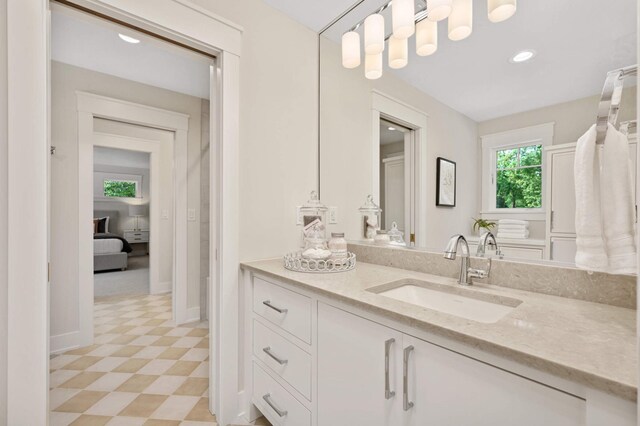 bathroom featuring tile patterned floors, baseboards, recessed lighting, and vanity