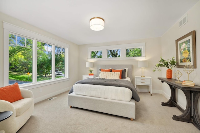 carpeted bedroom featuring baseboards and visible vents