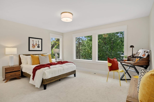 bedroom featuring carpet and baseboards