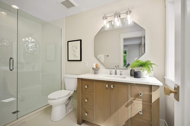 bathroom featuring tile patterned floors, toilet, vanity, visible vents, and a stall shower