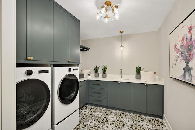 laundry area with a sink, washing machine and dryer, light tile patterned flooring, and cabinet space