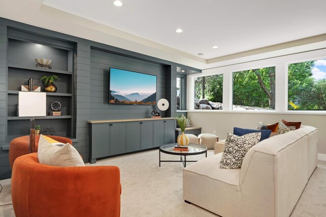 living room featuring recessed lighting, a wealth of natural light, built in features, and light colored carpet