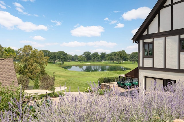 view of yard featuring golf course view and a water view