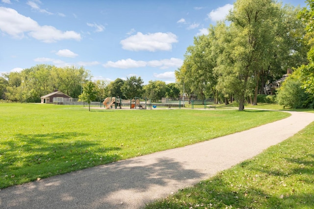 surrounding community featuring a yard, playground community, and fence