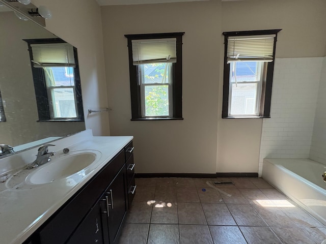 2108 Elliot Ave, Minneapolis, MN 55404 - full bathroom featuring vanity, a tub, tile patterned floors, and baseboards
