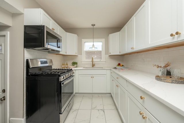 1634 Upton Ave N, Minneapolis, MN 55411 - kitchen with appliances with stainless steel finishes, a sink, light marble finish flooring, white cabinetry, and light stone counters