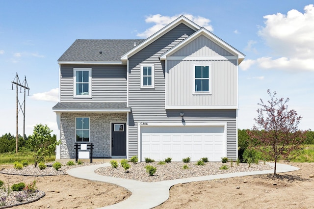 12514 Erskin St NE, Blaine, MN 55449 - view of front of home with a garage, roof with shingles, and stone siding