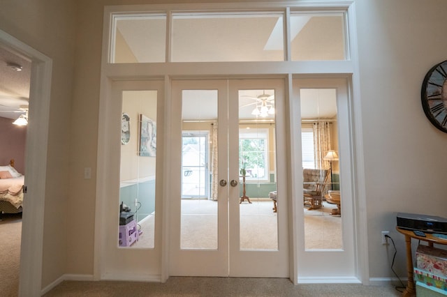 entryway with french doors and carpet flooring