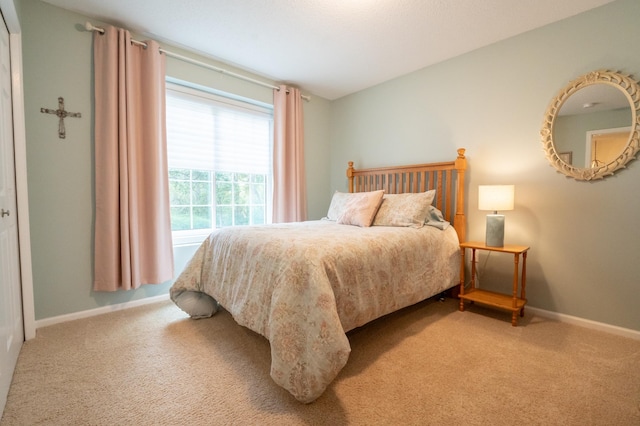 bedroom with carpet and baseboards