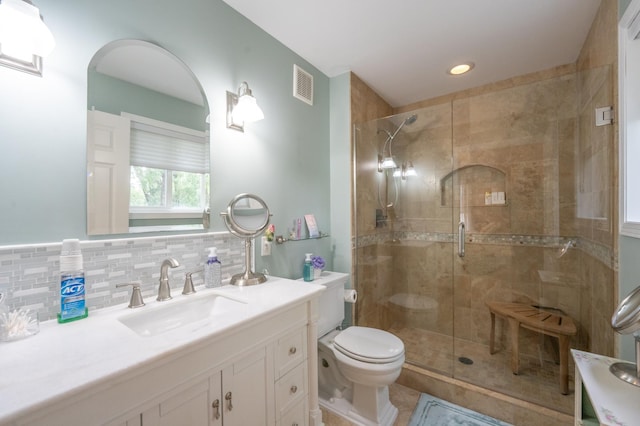 full bathroom with toilet, visible vents, a shower stall, and tasteful backsplash