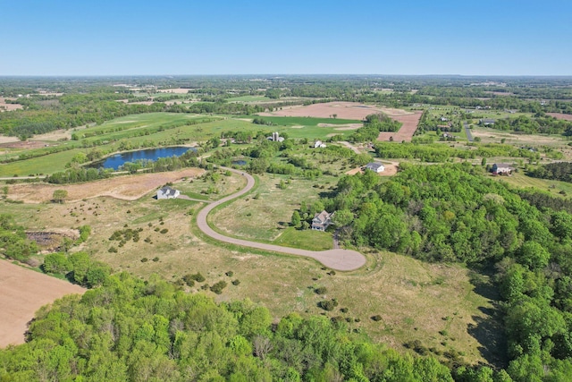 aerial view of property and surrounding area featuring a nearby body of water