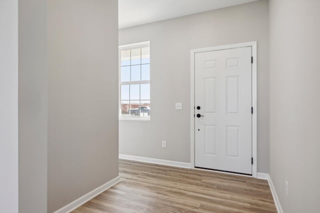 entrance foyer featuring light wood finished floors and baseboards