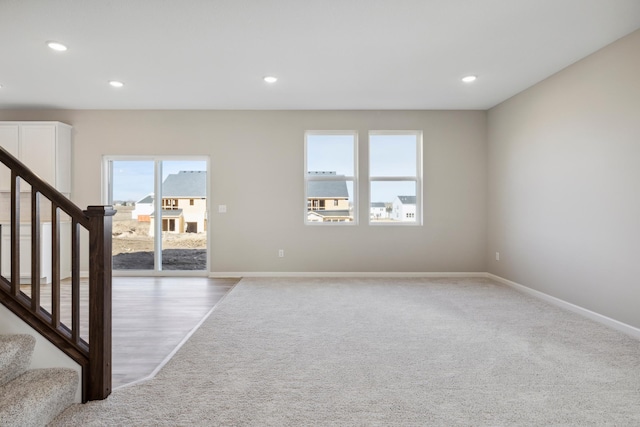 interior space featuring recessed lighting, a healthy amount of sunlight, and carpet