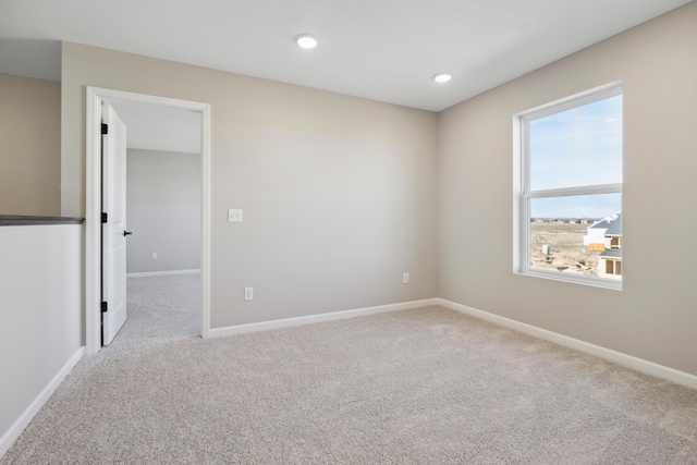 spare room featuring baseboards, recessed lighting, and carpet flooring