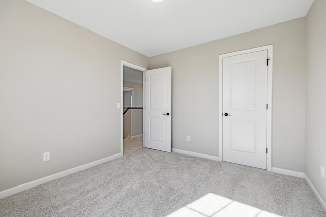 unfurnished bedroom featuring baseboards and carpet flooring