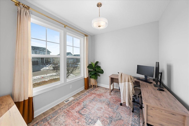 office featuring wood finished floors, visible vents, and baseboards