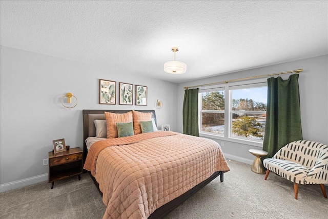 carpeted bedroom with baseboards and a textured ceiling