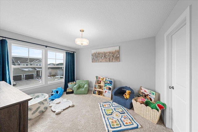 playroom featuring carpet floors and a textured ceiling